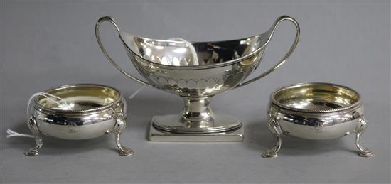 A George III silver boat-shaped salt, London 1788, Robert Hennell I and a pair of silver bun salts,